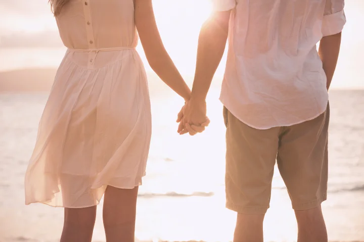 Couple se tenant la main sur une plage à l’île Maurice
