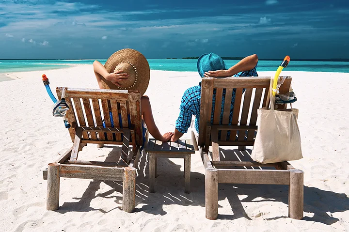 Couple se reposant sur des transats après une randonnée en snorkeling aux Maldives